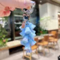 Exquisite iridescent blue lily of the valley keychain, detailed close-up of bag charm accessory. - Blue