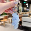 Acrylic rose bag charm detail showcasing the translucent blue floral beads and metal clasp. - Transparent Rose String - Blue