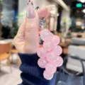 Detailed view of pink acrylic translucent grape keychain, glossy bead bag charm and accessory. - Transparent Pineapple String - Pink