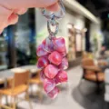 Detailed view of colorful crystal strawberry keychain with metallic clasp and shiny beads. - Colorful Heart String - Red