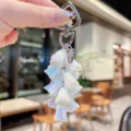 Close-up detail of the iridescent lily of the valley keychain with glossy pearlescent flower charms. - Colorful Lily of the Valley String - White