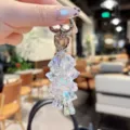 Detail shot of iridescent crystal lily of the valley keychain pendant with shiny metal hardware. - Transparent Lily of the Valley String - White