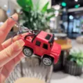 Red off road car keychain detail view, metal key ring pendant for bags and car keys. - Red