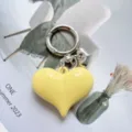 Candy color heart alloy keychain bag pendant detail view, minimalist cute metal key ring charm. - Yellow