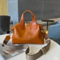 Leather crossbody bag detail showing premium oil wax cowhide texture and double zipper design. - 30x13x22cm / Sunset Yellow