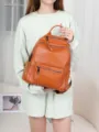 Stylish brown genuine leather women backpack with multi zipper pockets for daily travel use. - Caramel color
