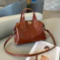 Detailed view of brown genuine leather shoulder bag featuring top handles and secure zipper. - 30x13x22cm / Brown