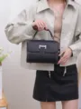 Classic black leather top handle bag with flap closure and metallic lock for women commuting. - Black