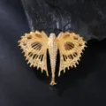 Close-up of a golden crystal rhinestone fish brooch, elegant fashion suit accessory detail. - Rhinestone Angel Brooch (XD825196)