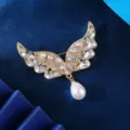 Gold angel wings brooch with sparkling rhinestones and elegant hanging pearl for men fashion. - Iridescent Angel Brooch (XD824431)