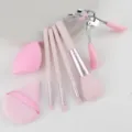 Detailed view of pink makeup brush set, sponge and eyelash curler for daily beauty - Pink