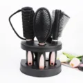 Black hair brush set with stand mirror and combs, professional styling hair tool detail view. - Pink
