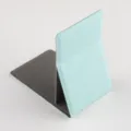 Detailed view of the portable folding makeup mirror stand in light blue leather and grey finish. - Light Blue