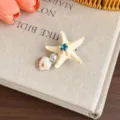 Chic starfish seashell hair clip with pearl and blue rhinestone for summer beach vacation main view. - Beige Starfish Pearl Shell Duckbill Clip / Beige