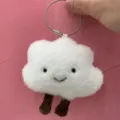 Close-up of cute white cloud plush bag charm with little brown legs and steel ring. - Cloud Bag Pendant