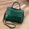 Green leather retro shoulder bag with crocodile embossed flap and top handle design. - Green