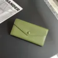 Green pebbled leather long wallet detail, sleek envelope design with snap button closure. - 19x10x3.5cm / Green