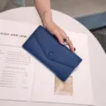 Blue genuine leather long envelope wallet detail showing soft pebble texture and snap button. - 19x10x3.5cm / Sapphire Blue