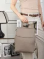 Detail view of the premium genuine leather backpack in taupe, soft texture for daily use. - Light Gray
