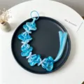 Blue braided hair extension with pearls and bows, detail view of cute children hair accessory. - Style 1