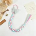 Detailed close-up of colorful braided hair extension with cute butterfly bow hair tie. - Style 1
