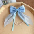 Blue bow hair clip with pearl tassels and shimmering details, elegant side accessory for sweet girls. - Blue