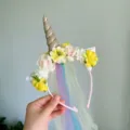 Close-up view of unicorn headband detail with colorful flowers and gradient tulle veil. - Yellow