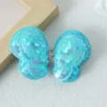Detailed shot of a light blue sequin butterfly hair clip showing texture and sparkling finish. - Blue Hair Clip