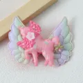 Close-up detail of a cute pink unicorn hair clip with iridescent angel wings for kids. - Rose Red