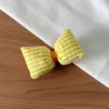 Vue détaillée du joli nœud papillon à carreaux jaune et blanc, texture en tissu doux. - Barrette Nœud Carreaux Jaune Alternative