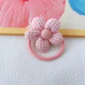 Pink gingham fabric flower hair tie detail close up, cute floral hair scrunchie accessory. - Pink