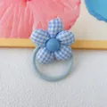 Detailed close-up of the blue gingham fabric flower hair tie, cute floral hair accessory. - Blue