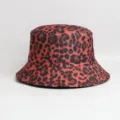 Detailed view showing the premium fabric texture and stylish red leopard print cap item. - One Size / Bucket Hat / Red & Black