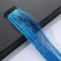 Close-up detail shot of shiny blue hair tinsel extensions with black clip for styling. - Lake Blue