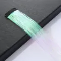 Close-up detail of colorful holographic hair tinsel extension strand with black clip. - Pink