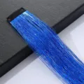 Close-up detail of blue shiny hair tinsel extension clip, sparkling metallic hair strand. - Sapphire Blue