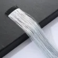 Detail shot of holographic hair tinsel extension with BB clip, sparkling metallic strands. - Silver