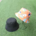 Double-sided bucket hat with abstract print and solid black, versatile casual sun protection hat. - One Size / Orange