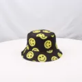 Black bucket hat with yellow smiley face print, wide brim sun protection outdoor cap. - One Size / Black