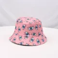 Pink printed bucket hat with eye patterns, ideal for outdoor travel, sun protection and daily. - Pink