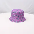 Purple bucket hat featuring an all-over blue and white eye print pattern for outdoor sun wear. - Purple