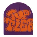 Purple knit beanie featuring a bold orange graffiti graphic design for stylish winter wear. - Purple