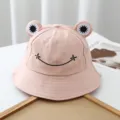 Cute frog bucket hat detail shot, pink cotton fabric with lovely embroidered eyes and smiley face. - Adjustable / Pink