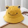 Detail shot of cute yellow bucket hat featuring 3D frog eyes and black smile embroidery. - Adjustable / Yellow