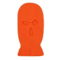 Close-up detail view of bright orange knitted three-hole ski mask, windproof winter thermal gear. - Orange Red