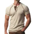 Detailed view of men's waffle knit short sleeve Henley shirt with contrast trim and button placket. - Khaki