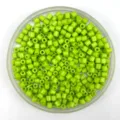 Close-up detail of bright green acrylic barrel beads for DIY bracelets and necklaces crafting. - 4*4mm / Grass Green