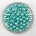Light blue imitation pearl beads detail shot, showing pearlescent shine for DIY jewelry crafts. - Lake Blue