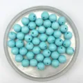 Close up detail of blue acrylic dotted round beads for DIY jewelry making and craft projects. - 8mm / Lake Blue