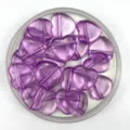 Close-up of translucent purple heart acrylic beads with horizontal hole, perfect for DIY jewelry. - Transparent Purple